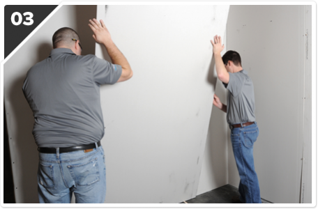 Two Men Adjusting a Board